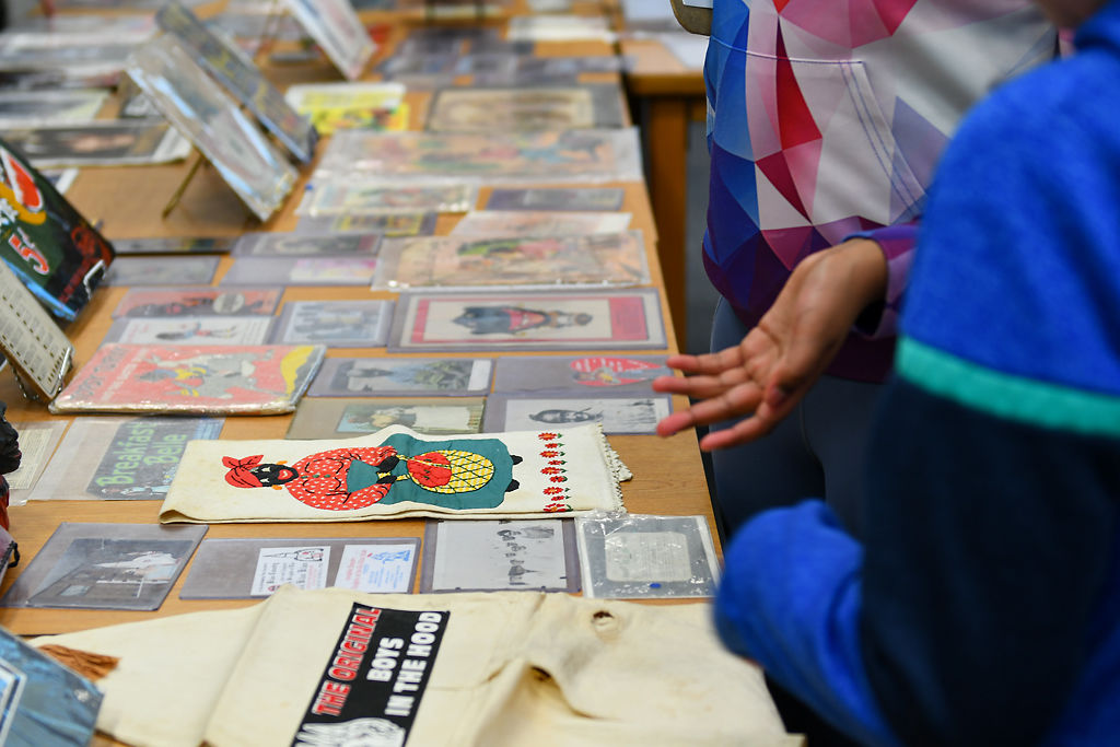 Lakira Briscoe gestures to racist materials included in the Black History 101 Mobile Museum